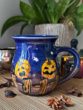 Black Cats and Pumpkins on the Fence