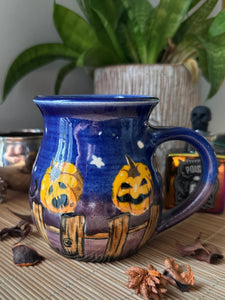 Black Cats and Pumpkins on the Fence