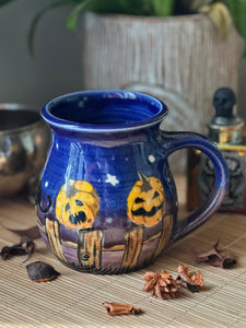 Black Cats and Pumpkins on the Fence